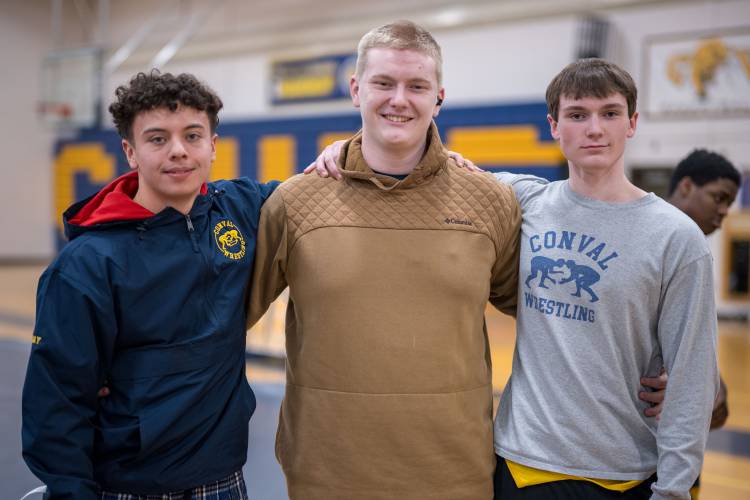 ConVal seniors Drake Bay, left, and Solomon Page, right, with junior teammate Bishop Benham before Wednesday's meet. 