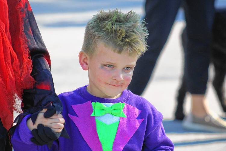 Griffin Arel as The Joker walks in the costume parade.