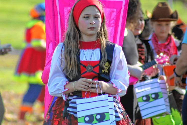 Pirate Lily Genetti collects candy from several stops along the Mason Elementary School parade.