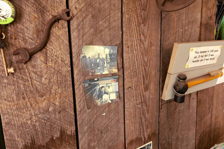 Two images of Joe MacGregor hang next to the register of the Bennington Garage. 