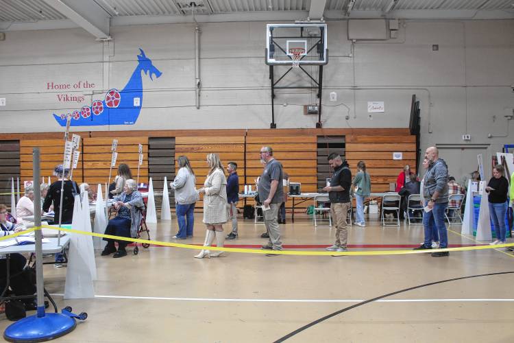 Residents line up to vote in the Mascenic Regional High School in New Ipswich gymnasium on Tuesday.