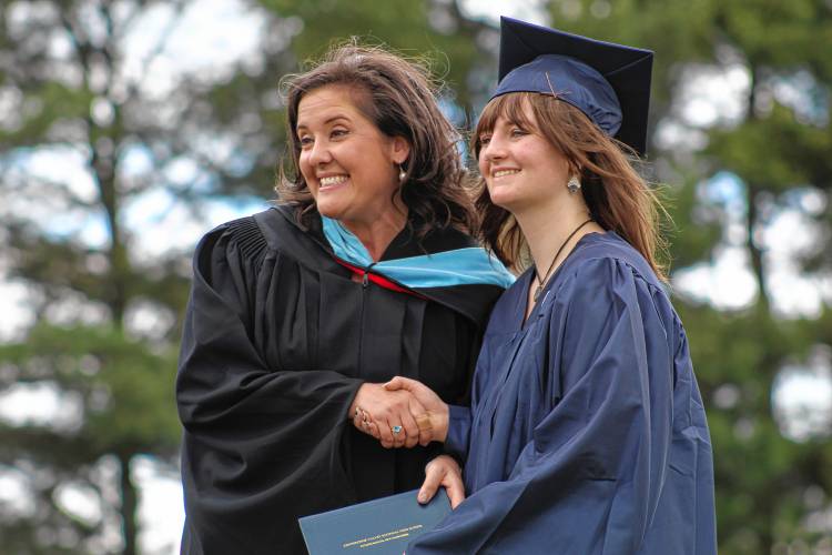 Riley Batty receives her diploma from Principal Heather McKillop.